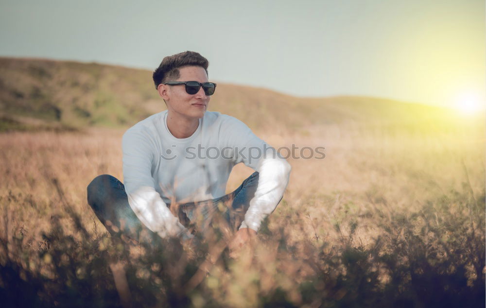 Similar – thoughtful little boy sitting on field