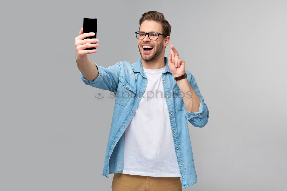 Similar – Man using his mobile phone.