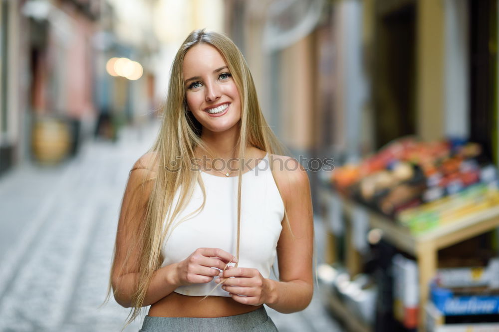 Smiling young woman in urban background.