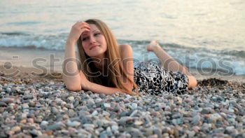 Similar – Young woman sitting on the banks of the Rhine with her feet in the water