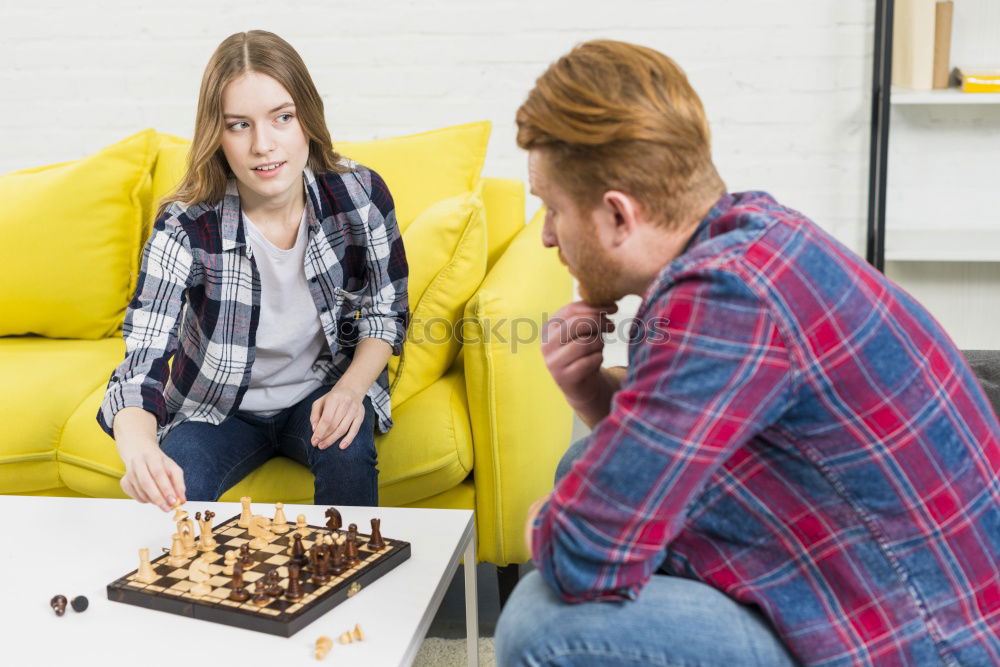 Similar – Girl and boy playing chess at home