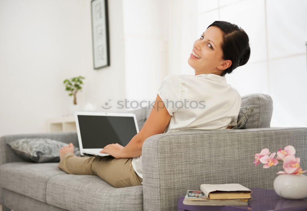 Similar – woman with laptop on her sofa at home