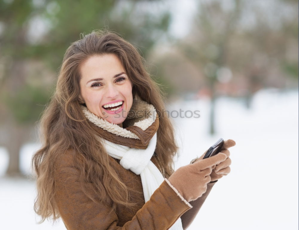 Similar – Beautiful Smiling Woman in red coat with mobile phone in hands, smartphone, urban scene