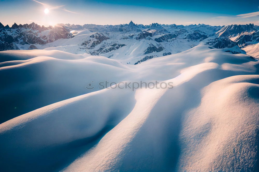 Similar – Snowy blue mountains in clouds at sunset