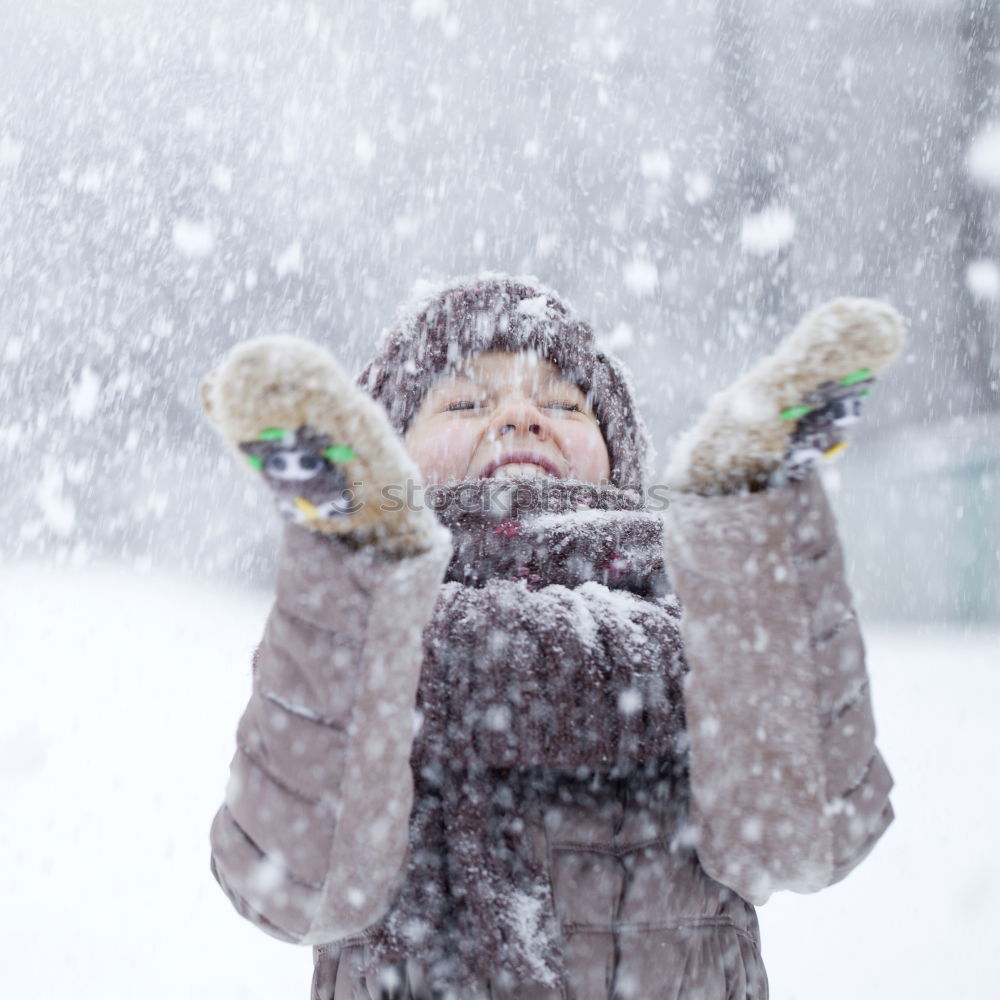 Similar – Image, Stock Photo Happy little girl enjoying snow. Child playing outdoors walking through deep snow in wintertime while snow falling. Toddler is wearing dark blue snowsuit