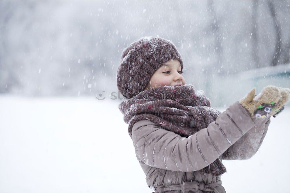 Similar – Image, Stock Photo Happy little girl enjoying snow. Child playing outdoors walking through deep snow in wintertime while snow falling. Toddler is wearing dark blue snowsuit