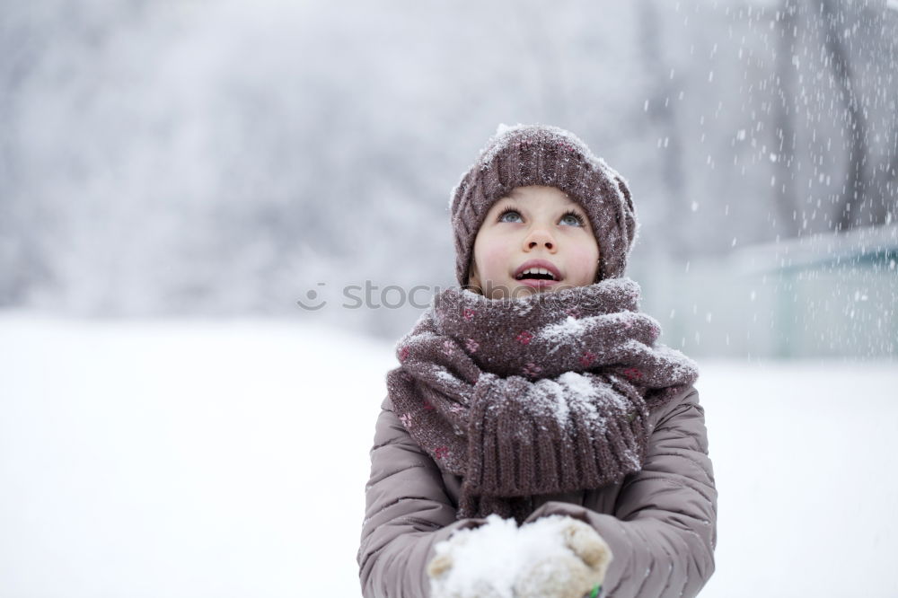 Similar – Image, Stock Photo Happy little girl enjoying snow. Child playing outdoors walking through deep snow in wintertime while snow falling. Toddler is wearing dark blue snowsuit