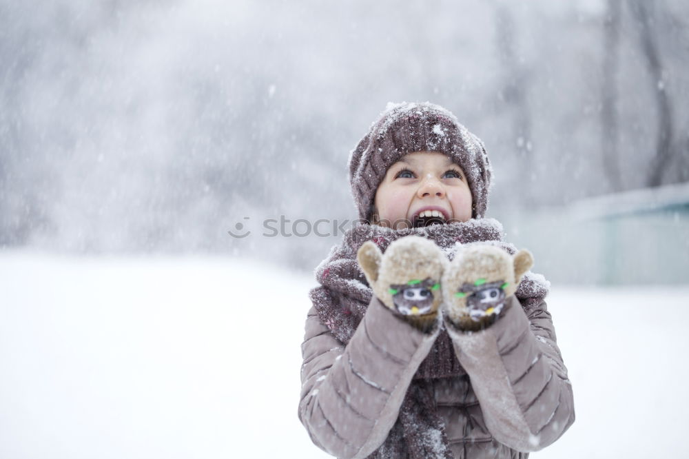 Similar – Happy little girl enjoying snow. Child playing outdoors walking through deep snow in wintertime while snow falling. Toddler is wearing dark blue snowsuit