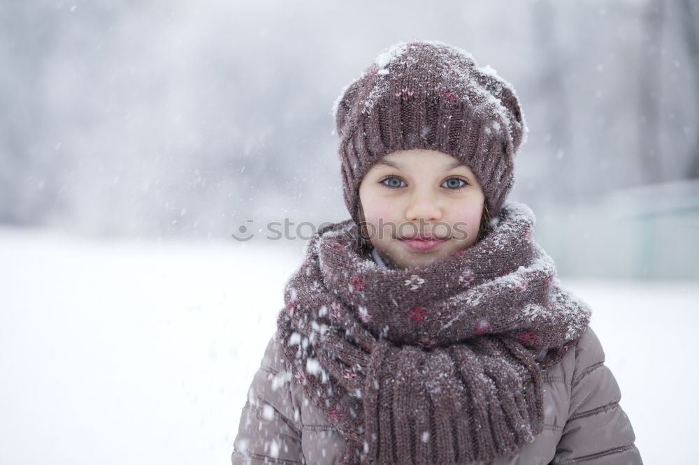 Similar – Image, Stock Photo Happy little girl enjoying snow. Child playing outdoors walking through deep snow in wintertime while snow falling. Toddler is wearing dark blue snowsuit