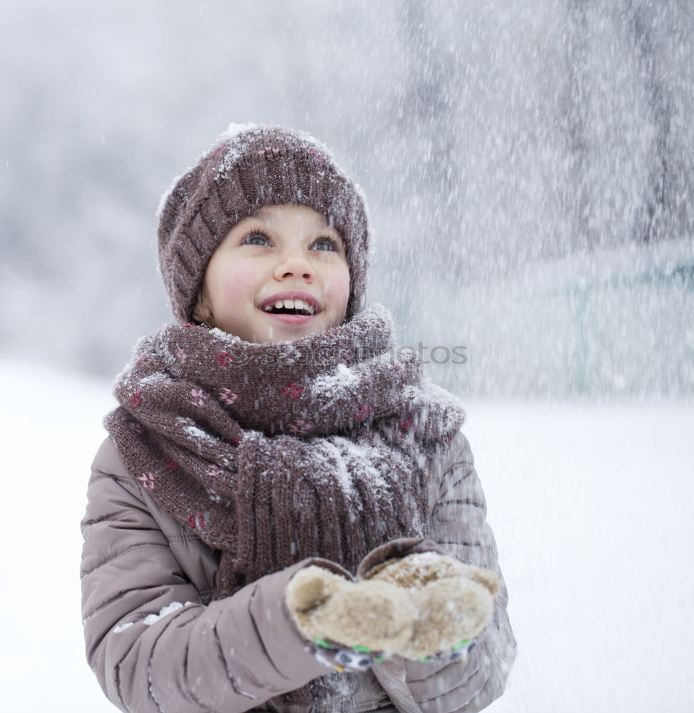 Similar – Little boy having fun playing with fresh snow during snowfall. Baby catching snowflakes on gloves. Kid dressed in warm clothes, hat, hand gloves and scarf. Active winter outdoors leisure for child