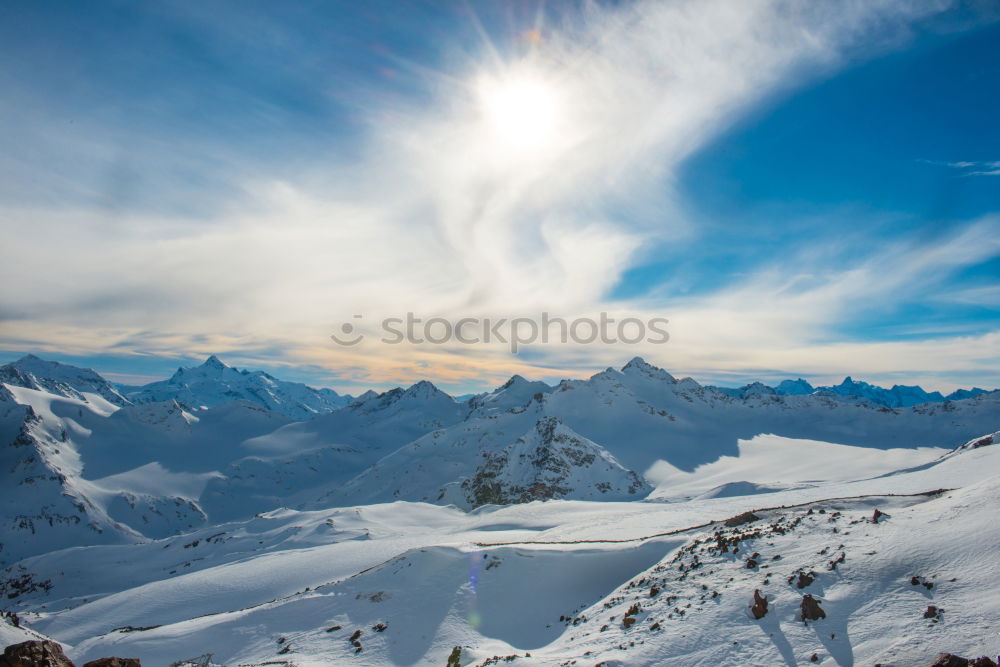 Similar – Image, Stock Photo Snowy blue mountains in clouds at sunset