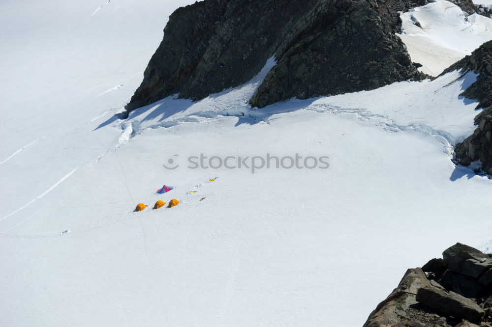 Similar – Female climber in the storm during an extreme winter climb