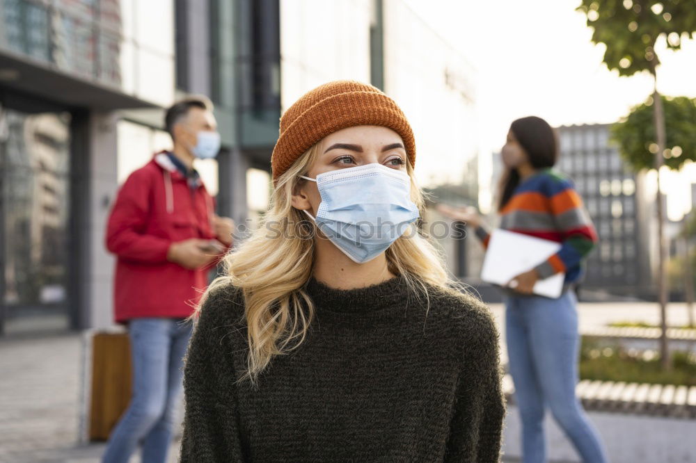 Similar – Young woman in medical mask standing near blooming flowers