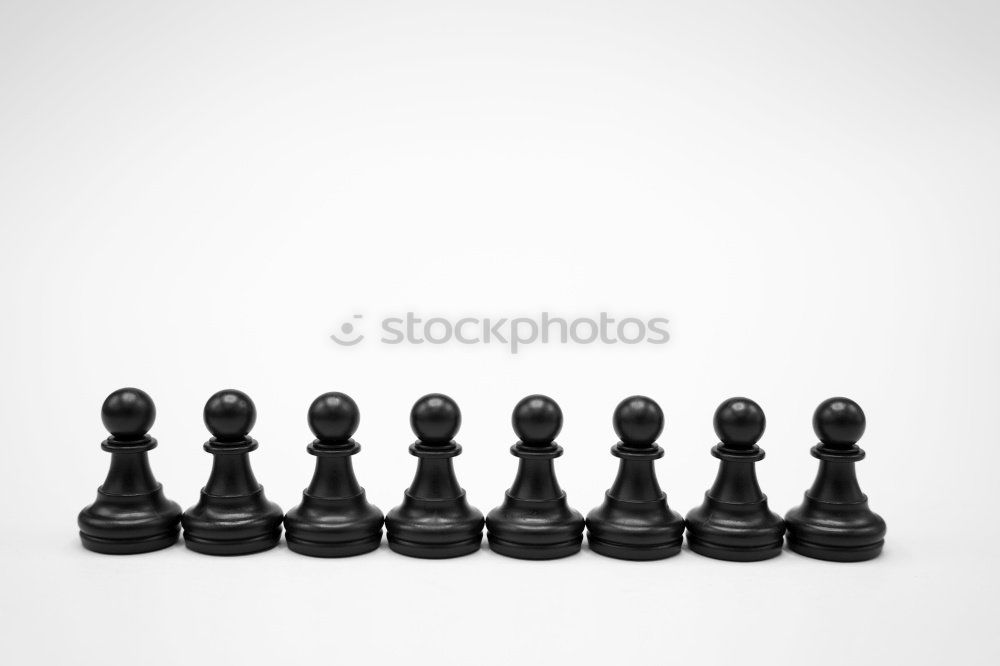 Similar – Red game piece in a row of black game pieces