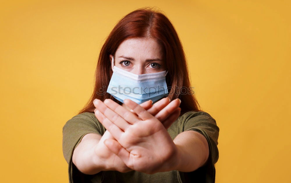 Similar – young woman who is wearing a mask under her nose in the wrong way