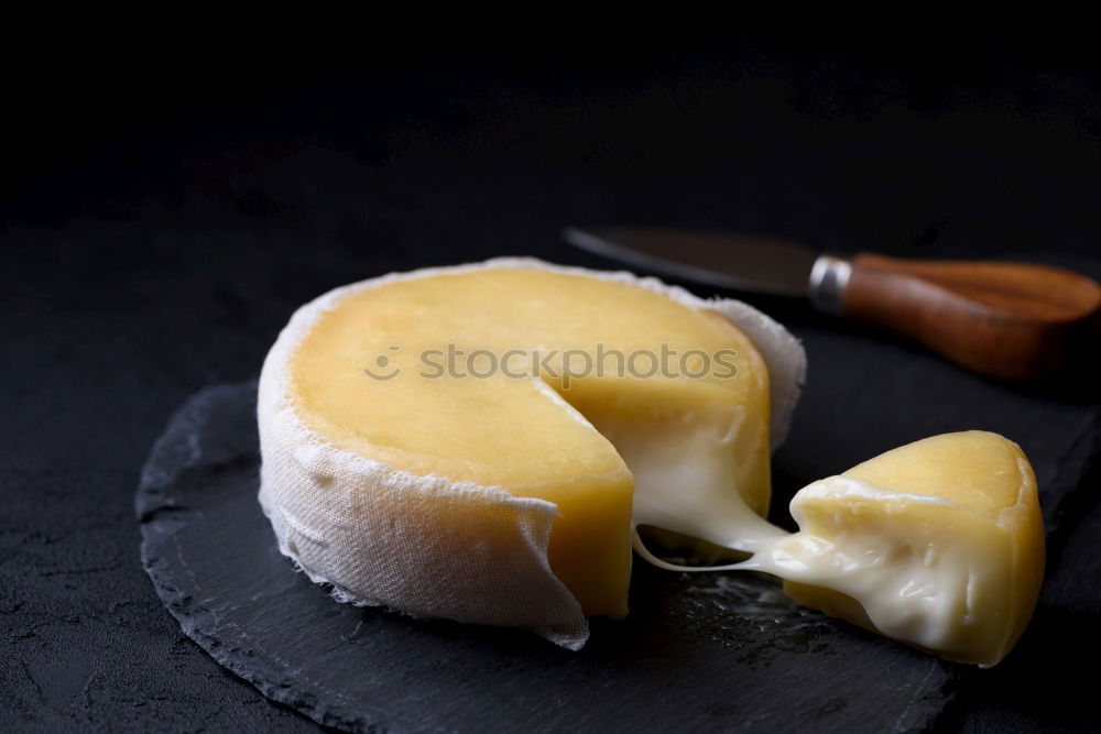 Fresh ripe lemons on dark stone