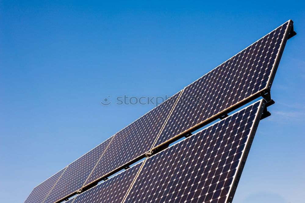 Similar – Photovoltaic panels in a solar power plant over a blue sky.