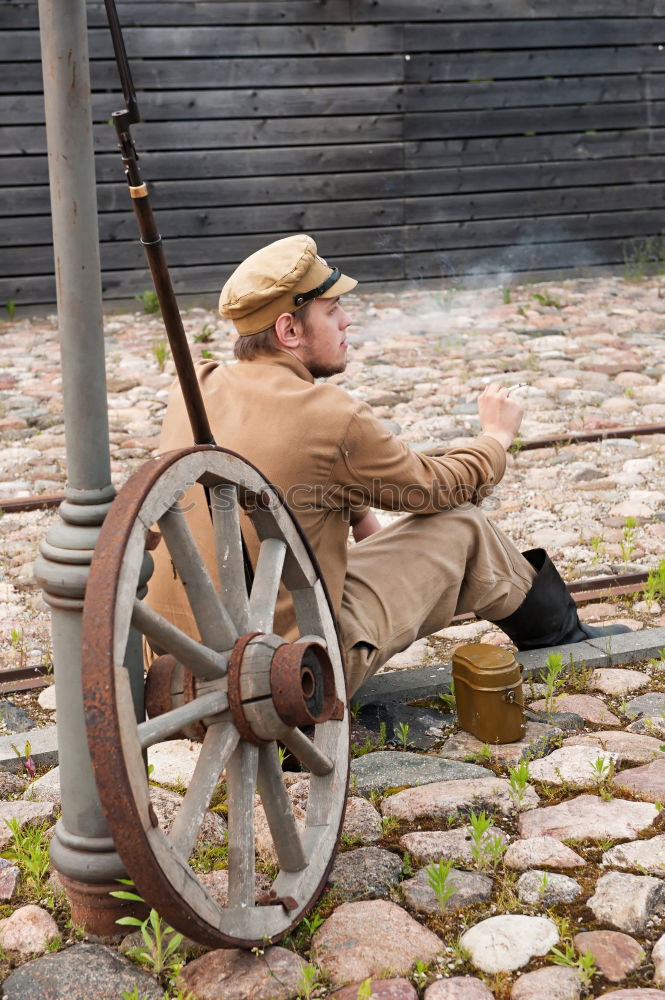 Image, Stock Photo Portrait of a young male adjusting the saddle on his horse