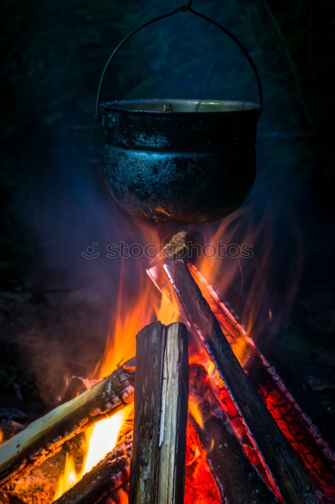 Similar – Blacksmith forges iron on anvil