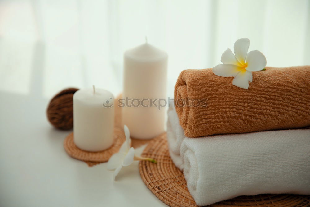 Similar – Spa Massage Zubehör mit Handtüchern, Steinen und Blüten