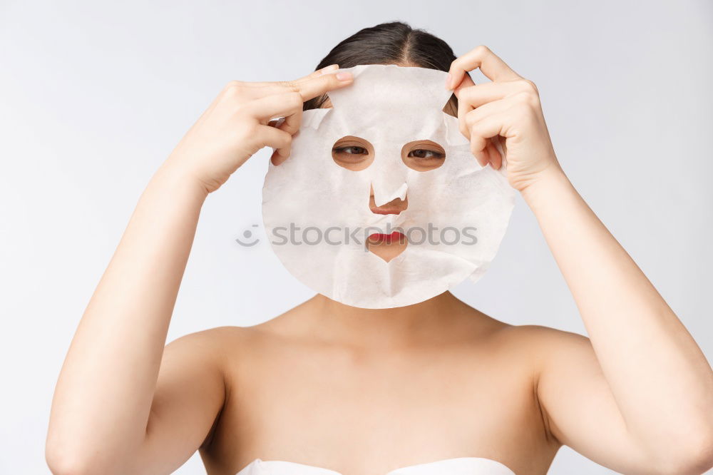 Similar – Image, Stock Photo Woman with bathrobe and towel on her head enjoys a face mask and holds two slices of cucumber in front of her eyes. Wellness, face care.