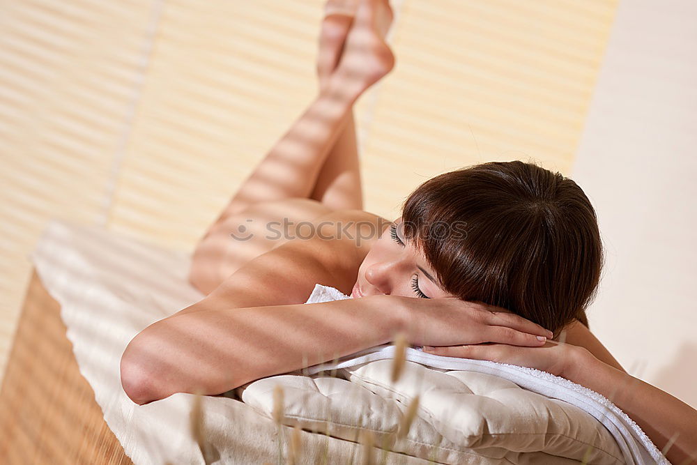 Young blond woman having massage in the spa salon.