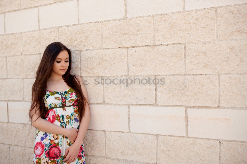 Similar – Beautiful young woman standing next to modern building.