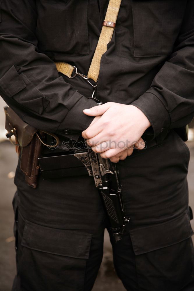 Similar – armed policeman with handcuffs from behind, partial view