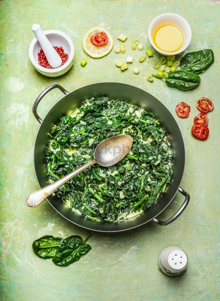 Spinach in cream sauce in casserole dish with spoon