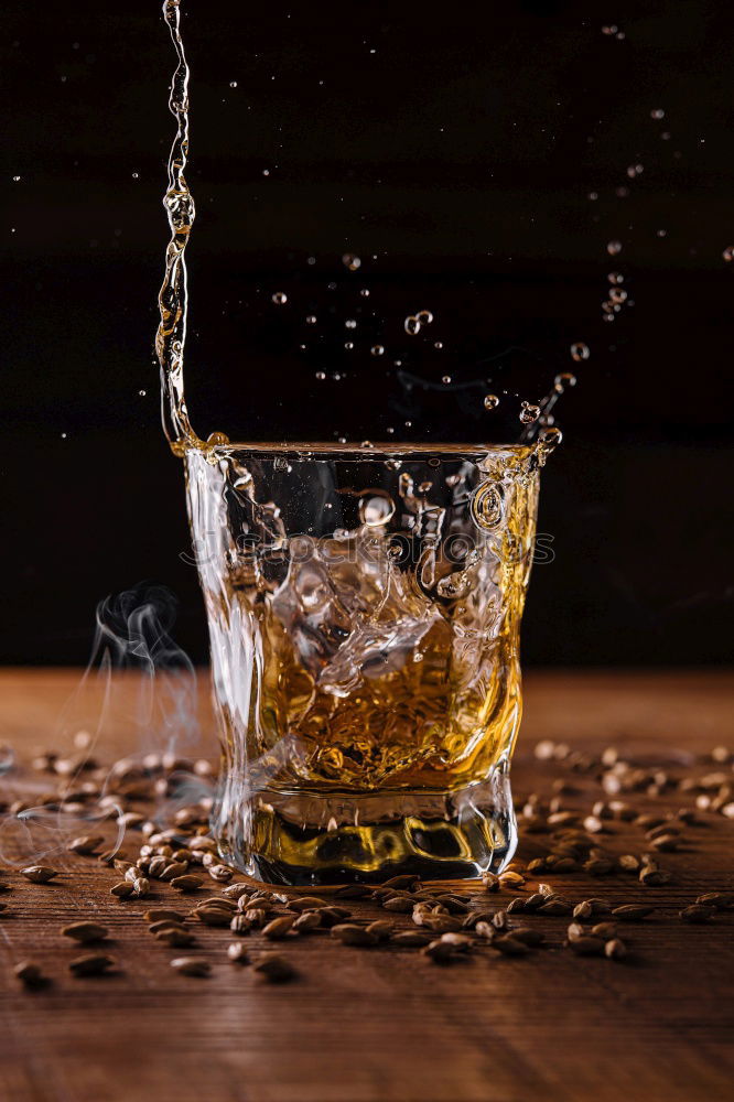 Similar – Glass of splashing whiskey