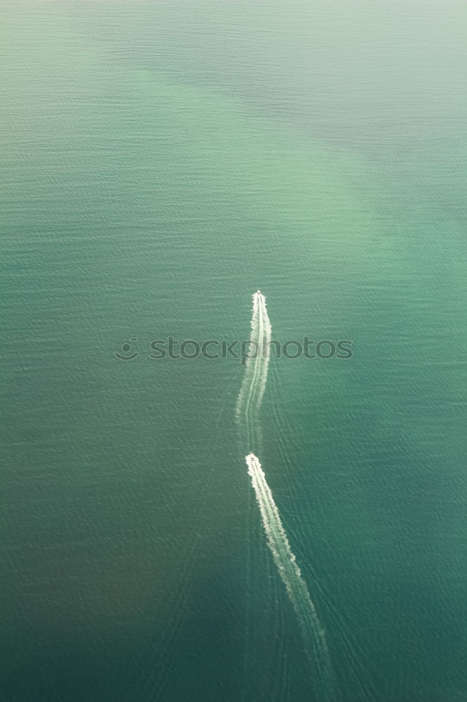 Similar – Image, Stock Photo In gliding flight a seagull flies in the upwind over the Pacific.  It can be seen alone in the picture. On the lower right. Otherwise only water is visible.