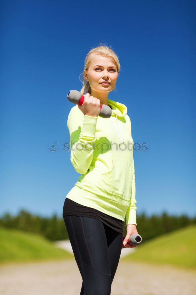 Similar – Woman tying hair in ponytail getting ready for run.