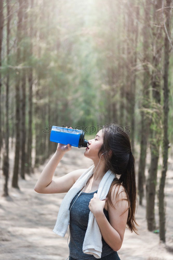 Similar – Fit sporty woman drinking water from a bottle