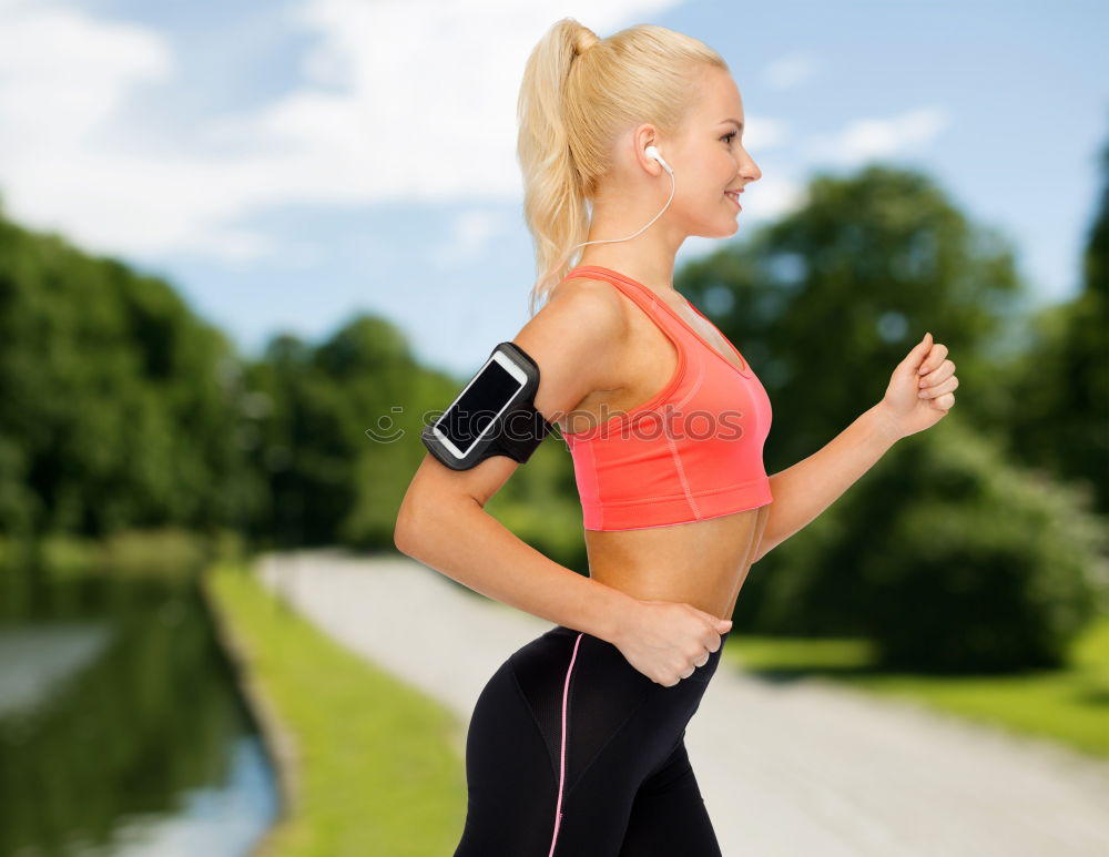 Similar – Woman jogging along a country road while listening to music