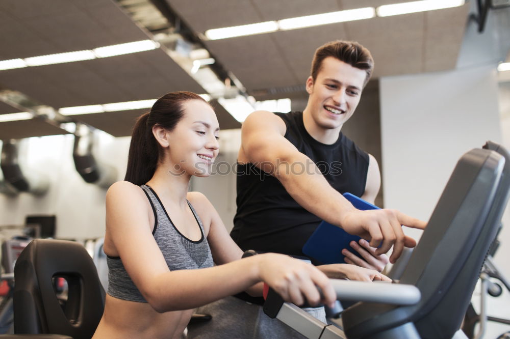 Similar – Image, Stock Photo Two people biking in the gym, exercising legs doing cardio workout cycling bikes