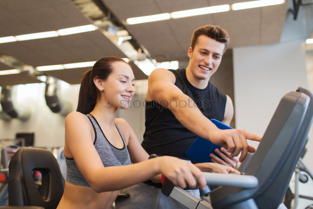 Similar – Image, Stock Photo Two people biking in the gym, exercising legs doing cardio workout cycling bikes