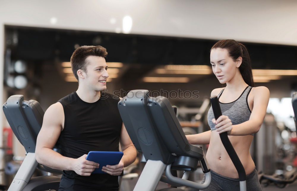 Similar – Image, Stock Photo Two people biking in the gym, exercising legs doing cardio workout cycling bikes