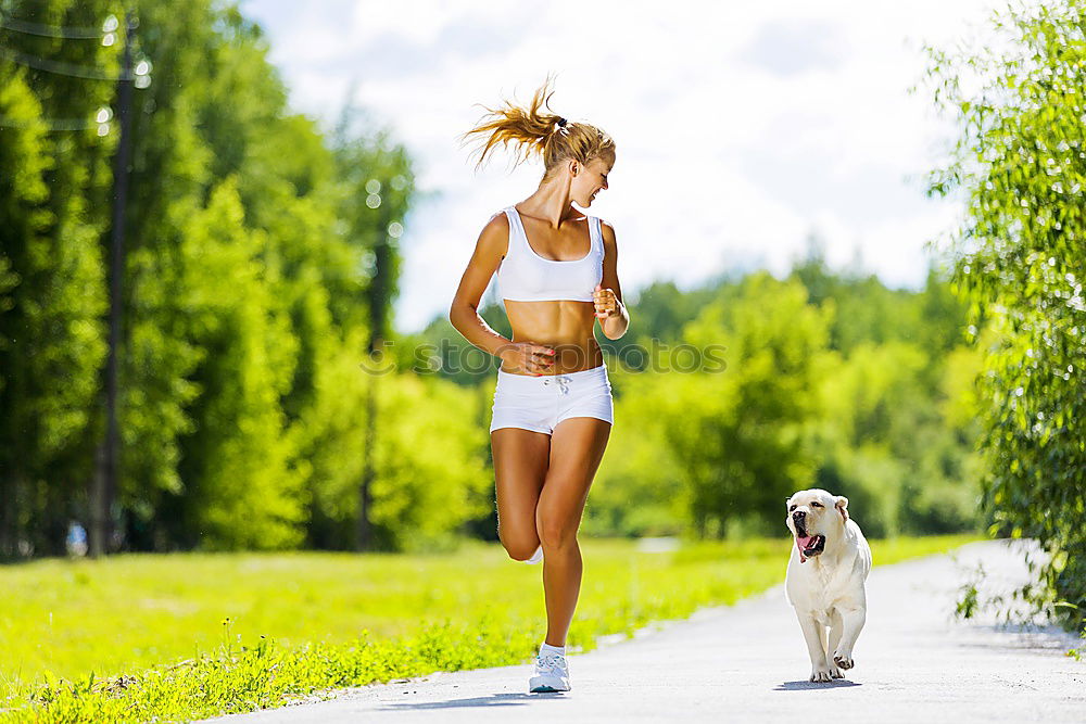 Similar – Healthy Woman Jogging in the Park with her Dog