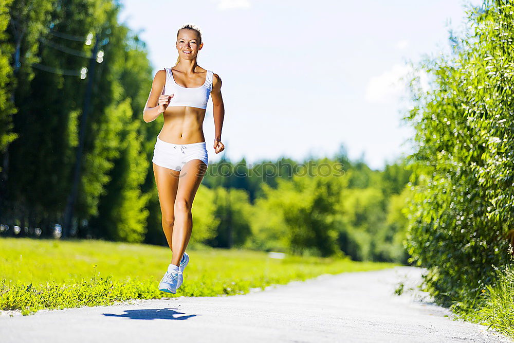 Image, Stock Photo Woman jogging along a country road while listening to music