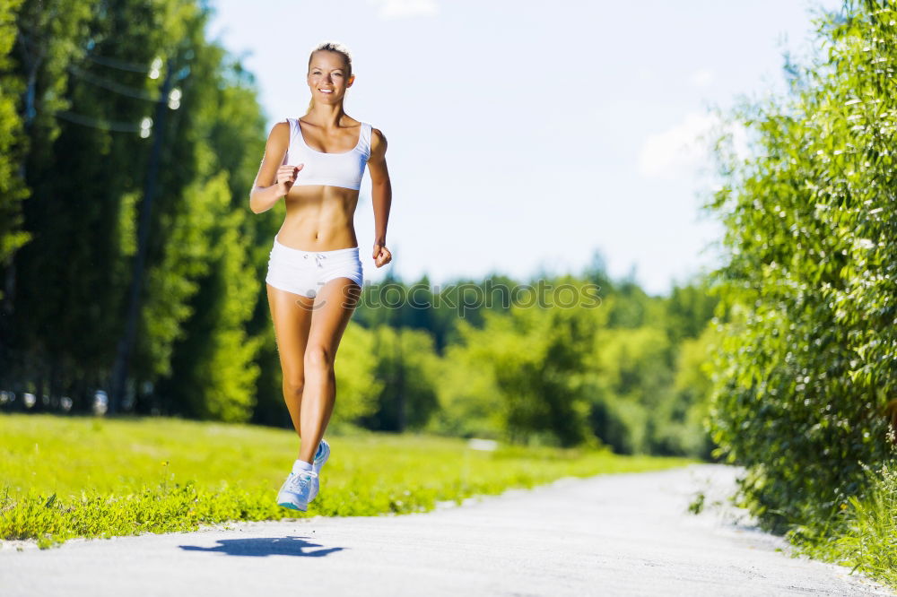 Similar – Woman jogging along a country road while listening to music