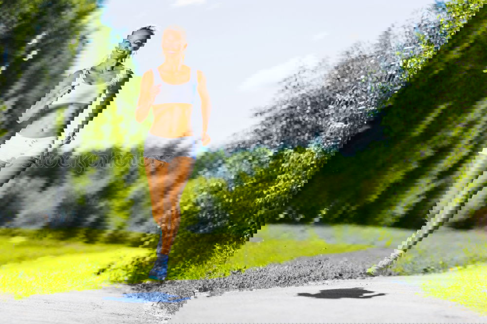 Similar – Image, Stock Photo Woman jogging along a country road while listening to music