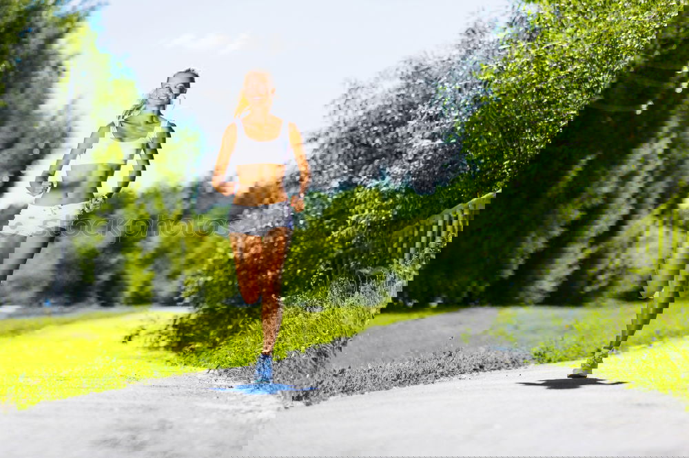 Similar – Image, Stock Photo Woman jogging along a country road while listening to music