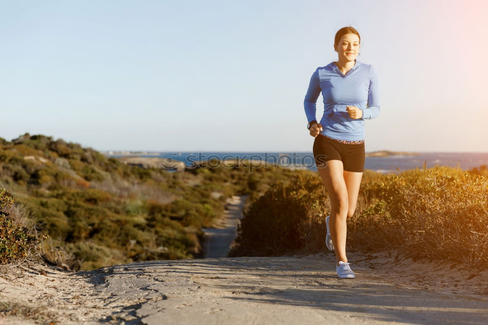 Similar – Fit middle-aged woman walking through a field