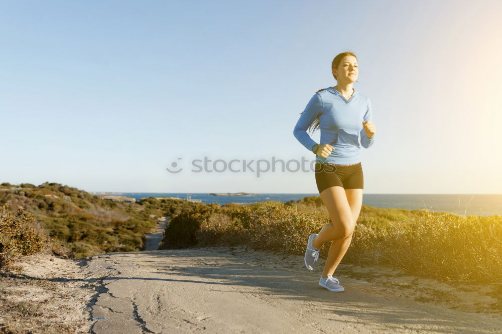 Similar – Man running at sunset on a sandy beach in a sunny day