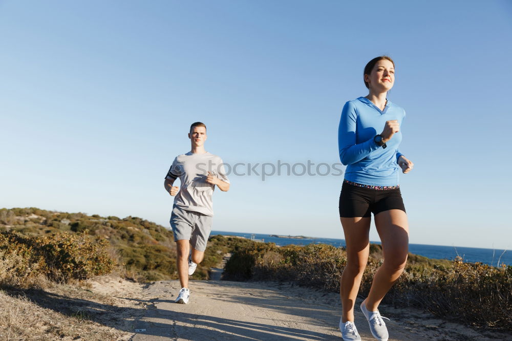 Similar – Man running at sunset on a sandy beach in a sunny day