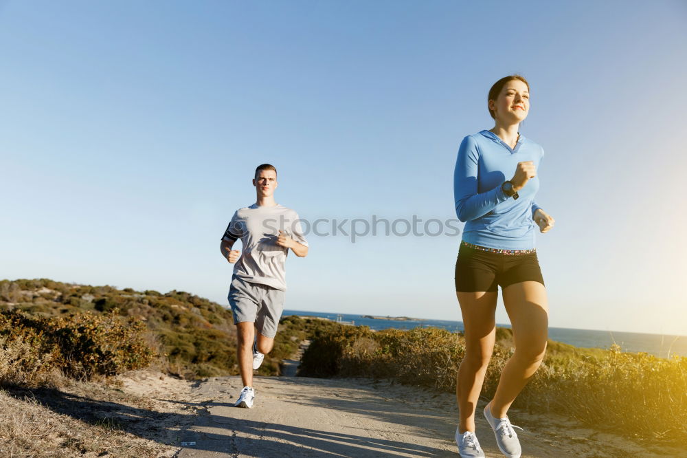 Similar – Man running at sunset on a sandy beach in a sunny day