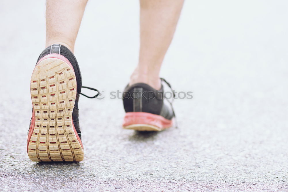 Similar – Image, Stock Photo Close-up shot of man tying running shoes with foot on the bench. Getting ready before jogging. Going in for sports, healthy lifestyle