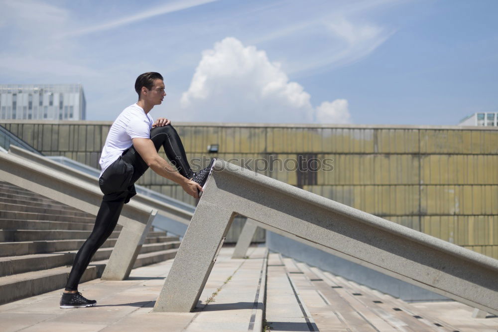 Muscular man working out in the city