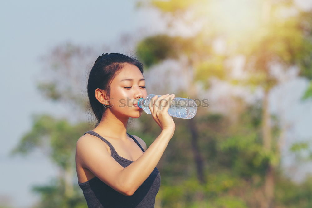 Similar – Fit sporty woman drinking water from a bottle