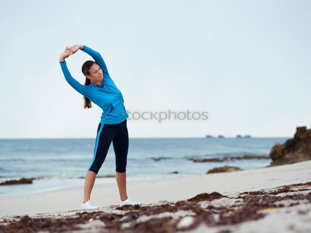 Similar – Fit female athlete drinking water after workout on beach